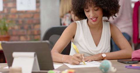 Confident Businesswoman Writing at Office Desk - Download Free Stock Images Pikwizard.com