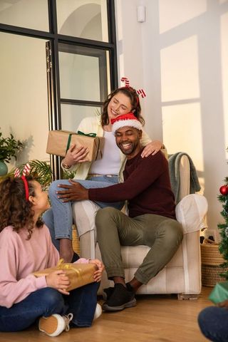Family gift exchange in cozy living room with holiday cheer