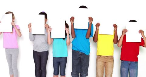 Children Holding Blank Pages Over Faces Against White Background - Download Free Stock Images Pikwizard.com