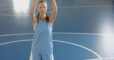 Female Basketball Player Preparing to Shoot on Indoor Court