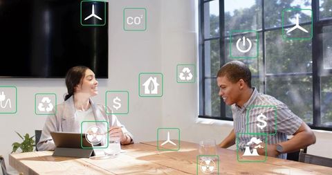 Discussing sustainable energy at modern office table with floating eco and finance icons