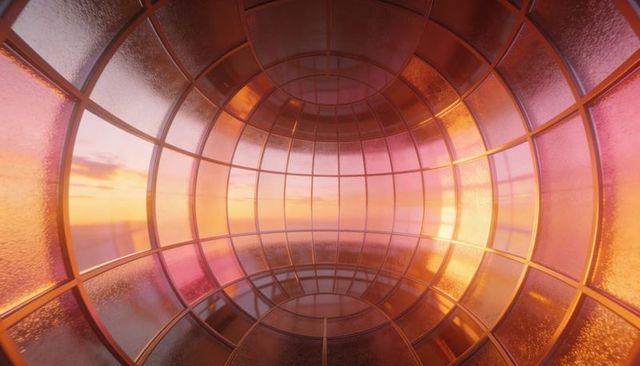 Glowing Glass Capsule Tunnel Reflecting Sunset Light with Curved Panes and Ringed Metal Grid