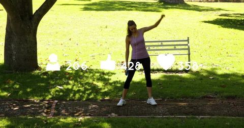 Stretching woman in purple tank top on sunny park path with bench and social media icons