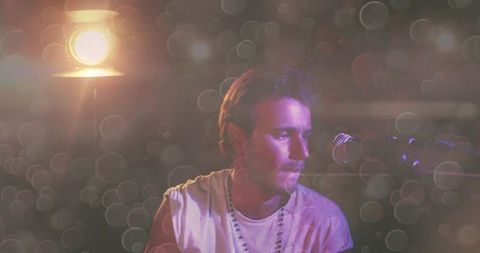 Solo Musician Performing in Atmospheric Lighting