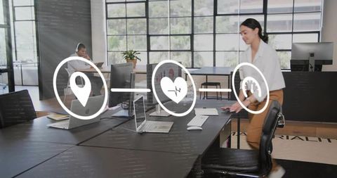 Woman Adjusting Chair in Open-Plan Office Surrounded by Laptops and Productivity Icons
