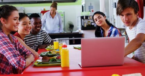 Diverse Teenagers Collaborating Around Laptop in School Cafeteria - Download Free Stock Images Pikwizard.com