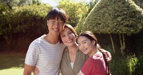 Smiling Family Enjoying Time Together Outdoors in Garden