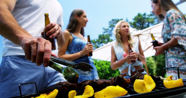 Friends Enjoying Outdoor Barbecue with Drinks - Download Free Stock Images Pikwizard.com