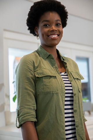 Confident Woman Standing in Modern Kitchen with Potted Plants