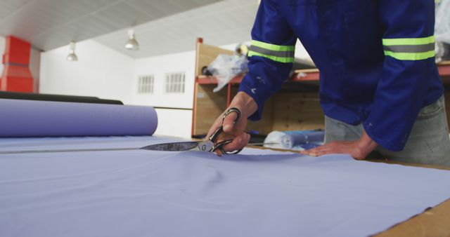 Tailor Cutting Blue Fabric with Scissors in Workshop - Download Free Stock Images Pikwizard.com