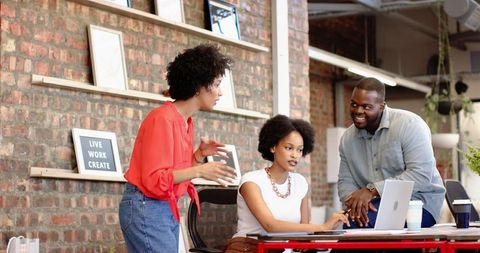 Collaborative meeting with diverse team in creative office environment