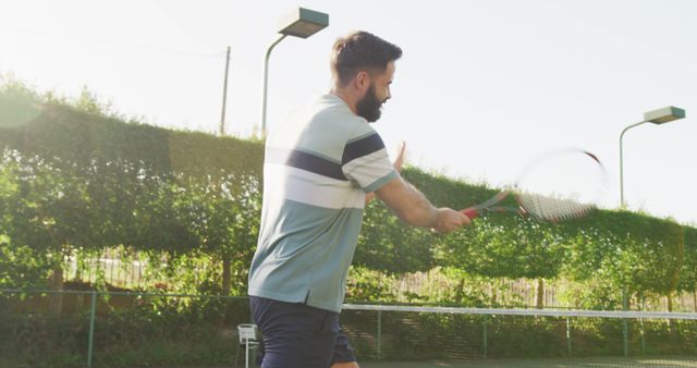 Man Playing Tennis Outdoors on Sunny Day - Download Free Stock Images Pikwizard.com