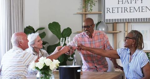 Senior Friends Toasting at Retirement Celebration with Champagne