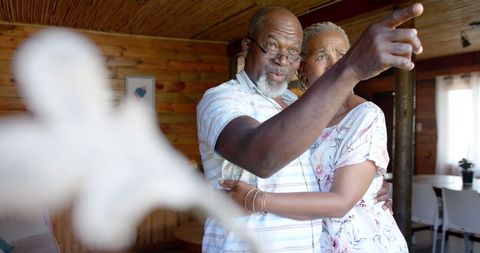 Happy Senior Couple Embracing in Cozy Wooden Home