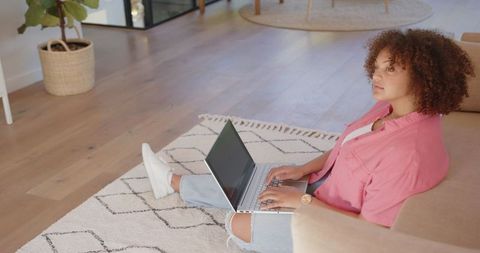 Young Woman Working on Laptop at Home in Cozy Modern Living Room