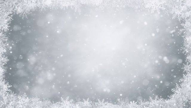 Frosted snowflake frame with glowing snowy center and falling bokeh for holiday design