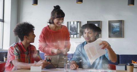 Young diverse team collaborating over tablet and documents with digital code overlay