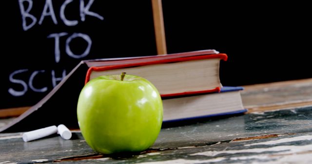 Green Apple on Teacher's Desk with Blackboard and Textbooks in Classroom - Download Free Stock Images Pikwizard.com