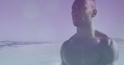 Shirtless Man on Tranquil Beach with Pastel Sky