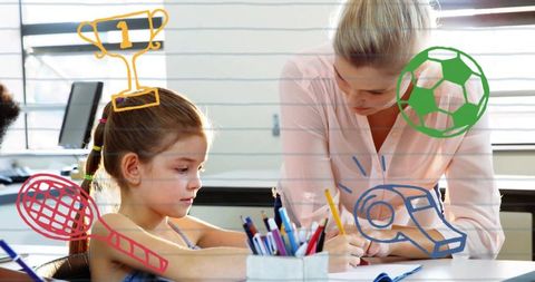 Tutor guiding elementary student writing during classroom learning with sports doodles