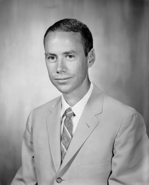 This black and white picture portrays a confident man in a suit from 1967. It is suitable for use in articles or projects focused on retro fashion, vintage photography, history, corporate life in the 1960s, or professional business themes. Great for illustrating stories about historical figures, interviews, and formal occasions.