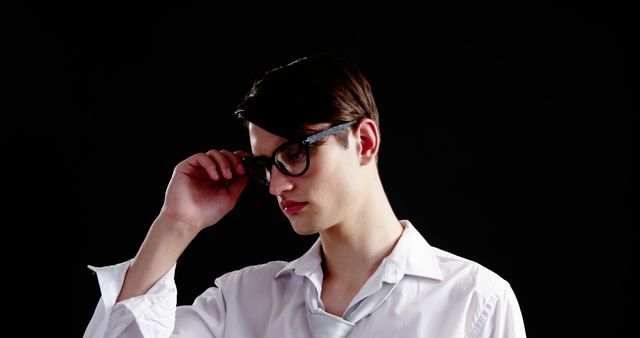 Young Professional Adjusting Glasses in Minimalist Space - Download Free Stock Images Pikwizard.com