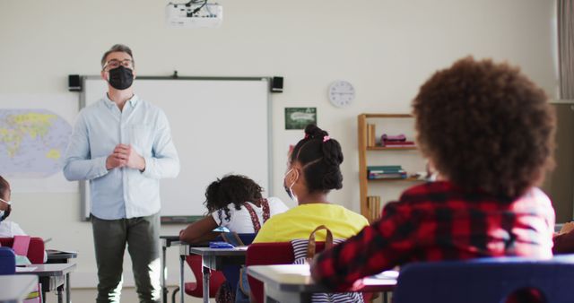 Masked Teacher Instructing Diverse Classroom During Pandemic - Download Free Stock Images Pikwizard.com