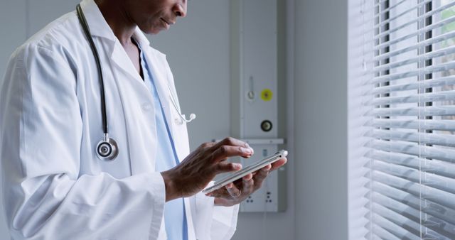 Healthcare Professional Using Tablet by Window in Hospital Room - Download Free Stock Images Pikwizard.com