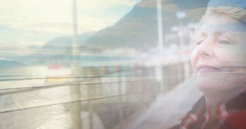 Contemplative senior woman enjoying serene coastal view