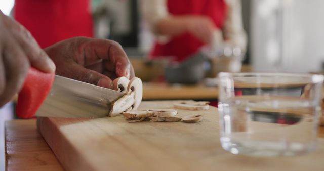 Chef Slicing Mushrooms on Wooden Cutting Board in Kitchen - Download Free Stock Images Pikwizard.com