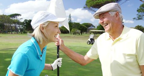 Elderly Golfers Sharing Joy on Sunny Course