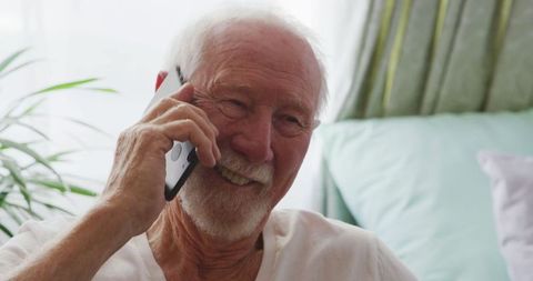 Happy Senior Man Talking on Smartphone in Retirement Home