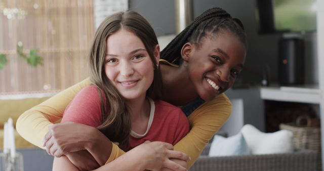 Happy teenage friends hugging indoors and smiling at camera - Download Free Stock Images Pikwizard.com