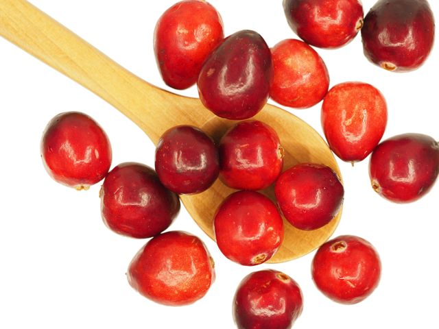 Fresh Red Cranberries Scattered on Wooden Spoon - Download Free Stock Images Pikwizard.com