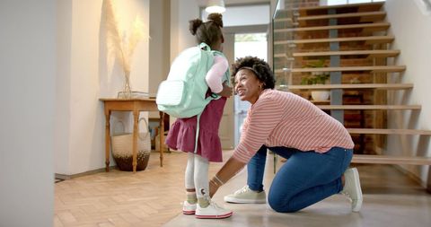 Mother Helping Daughter with School Bag at Home Entrance - Download Free Stock Images Pikwizard.com