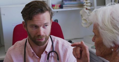 Doctor Consulting Senior Woman in Medical Office Amidst COVID-19