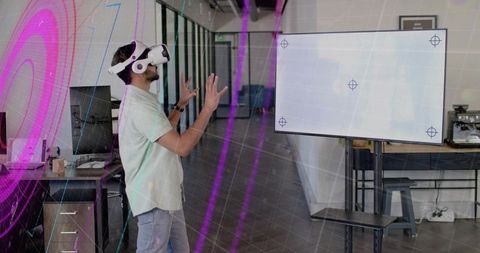 Man with vr headset innovatively gesturing at digital workspace screen
