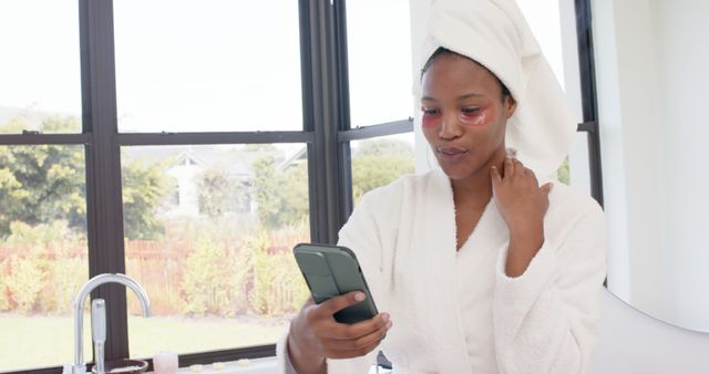 Woman in Bathroom Using Phone with Eye Patches - Download Free Stock Images Pikwizard.com