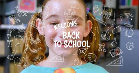 Smiling schoolgirl holding apple with welcome back to school doodles