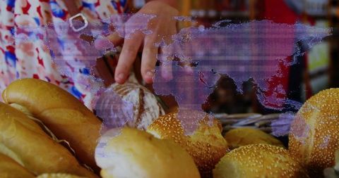 Hands picking artisan loaf at bakery counter with holographic world map overlay