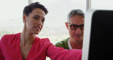 Business Professionals Collaborating on Computer in Office