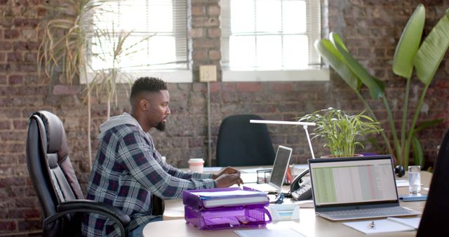 African American man working in chic urban office environment - Download Free Stock Images Pikwizard.com