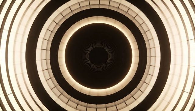Glowing concentric ceiling rings creating futuristic symmetry and geometric architecture