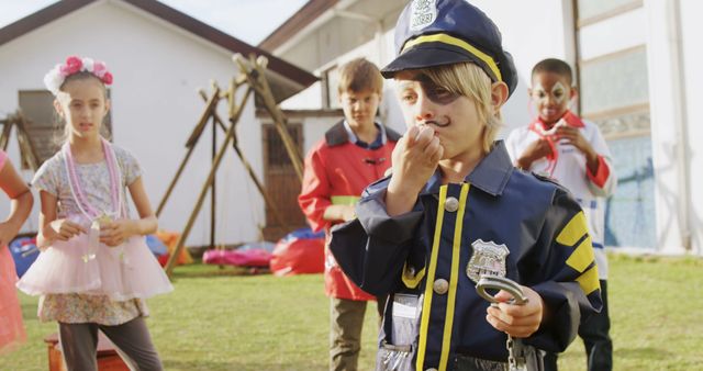 Children in various costumes enjoy playing outside at a festive party. Suitable for depicting themes of childhood, imagination, festivities, and social bonding. Perfect for educational materials, party planning websites, and advertisements focused on children's events.