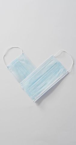 Face masks arranged in heart shape symbolizing healthcare and love