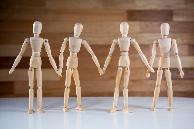 Conceptual image of figurine with holding hands together