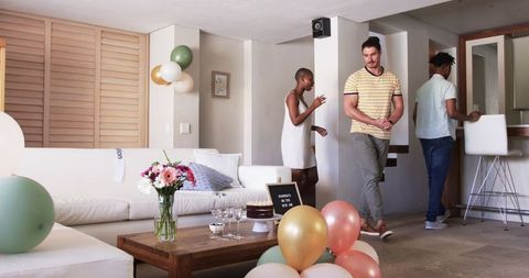 Friends Socializing at Home Gathering with Festive Decorations