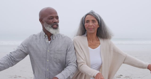 Senior African American Couple Enjoying Beach Walk on Foggy Day - Download Free Stock Images Pikwizard.com