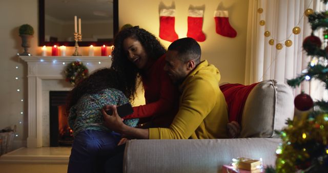 Family Enjoying Christmas Celebration by Fireplace with Decorated Tree - Download Free Stock Images Pikwizard.com