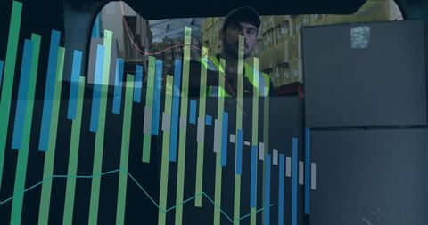 Logistics Worker Amidst Financial Graphs in Warehouse
